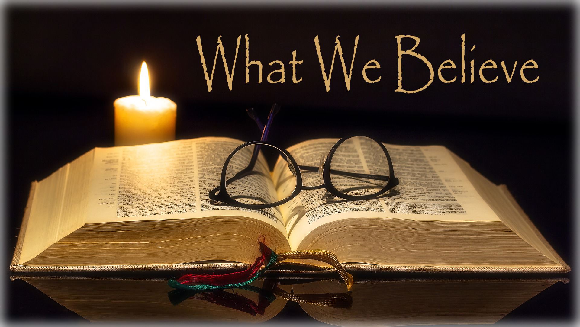 Bible with Reading Glasses and Candle